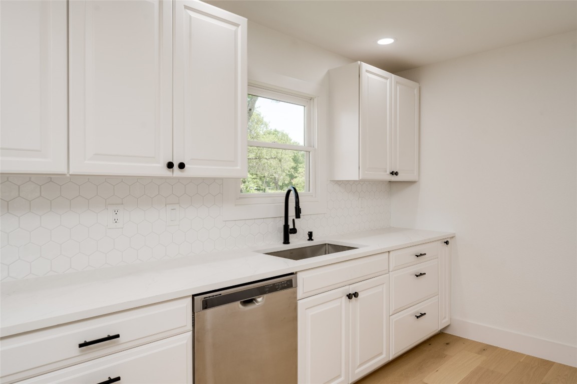 1928 Miles Avenue, Unit 1 Austin, TX 78745 - Photo 12 of 28 a kitchen with white cabinets and a window
