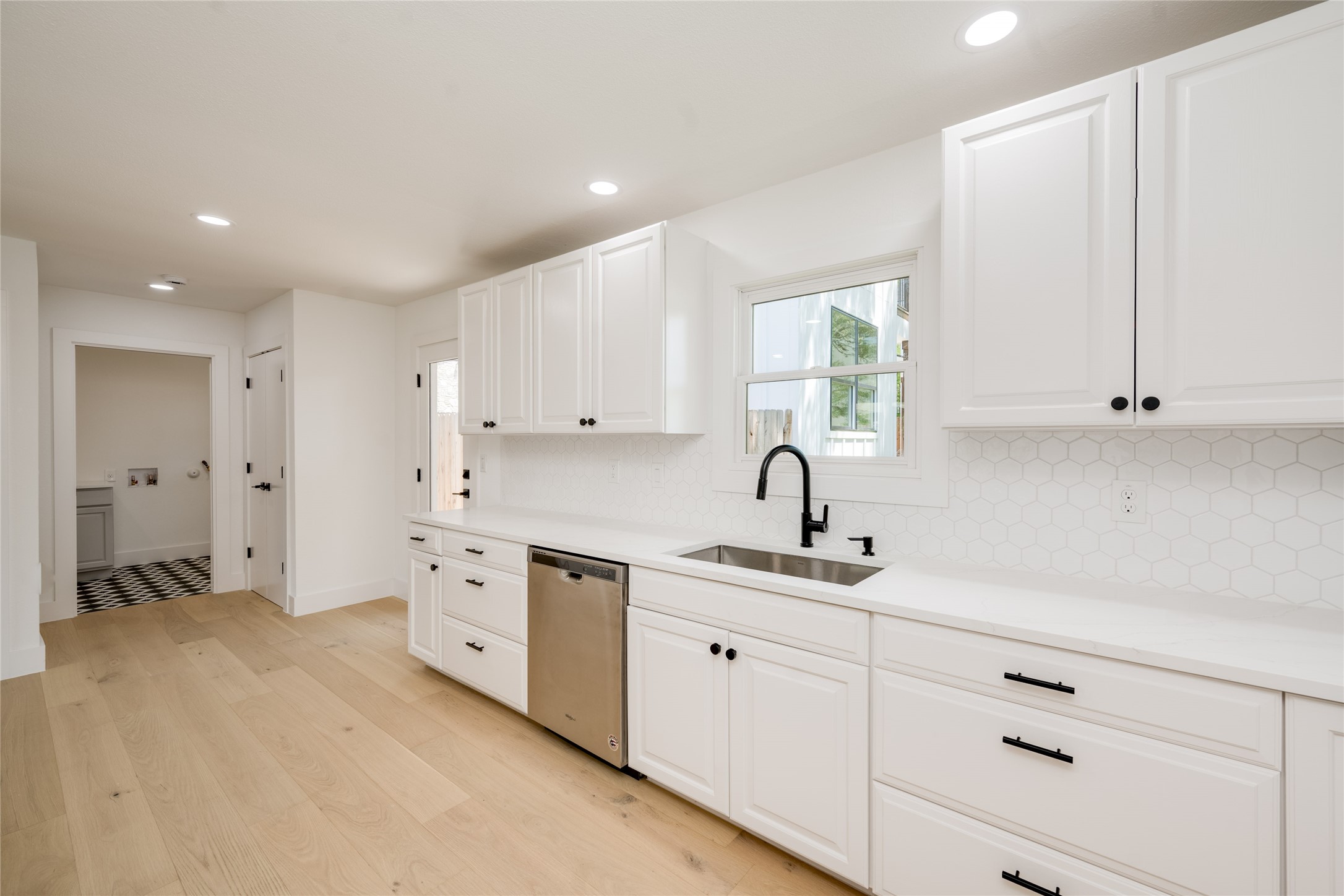 1928 Miles Avenue, Unit 1 Austin, TX 78745 - Photo 13 of 28 a kitchen with white cabinets and sink