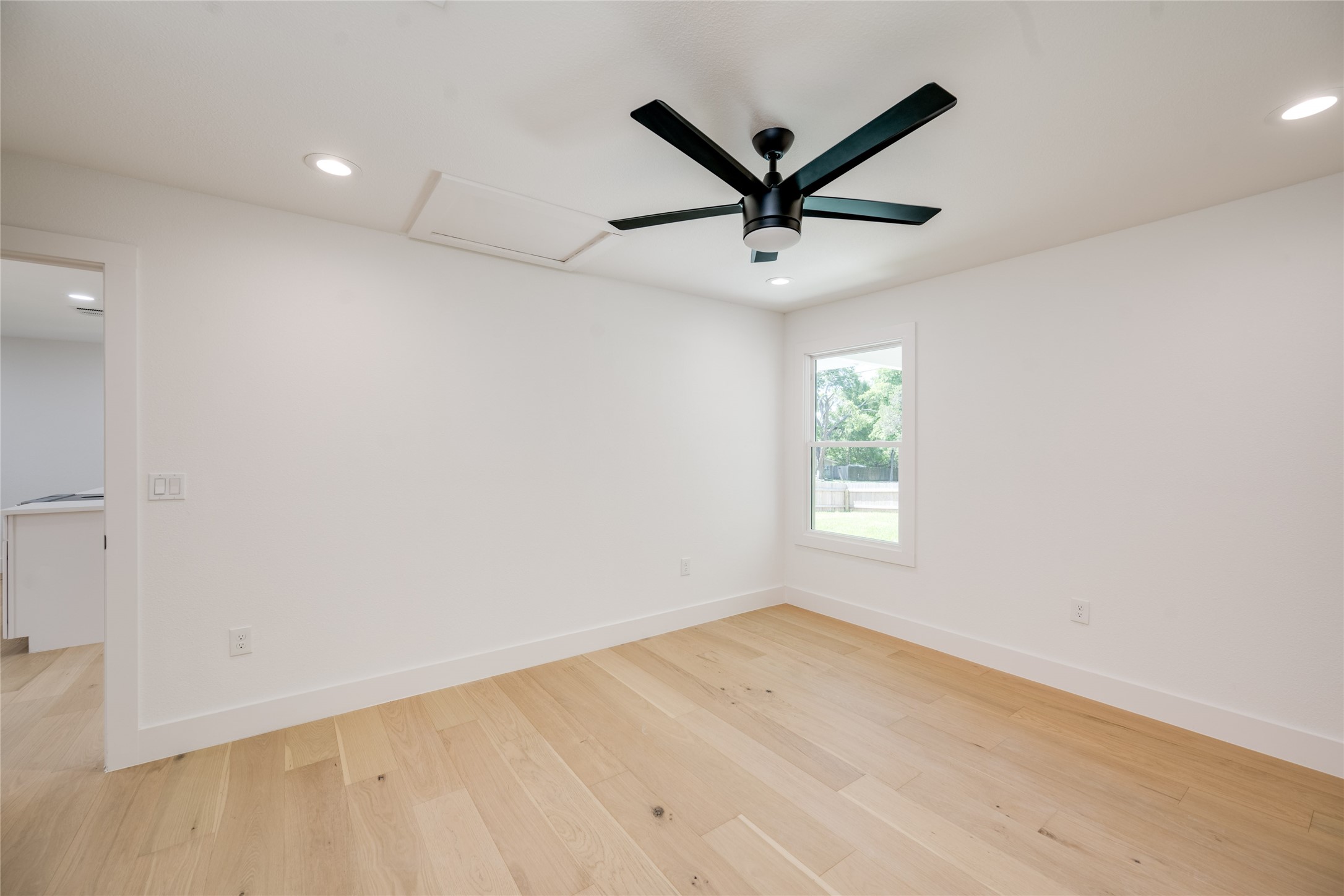 1928 Miles Avenue, Unit 1 Austin, TX 78745 - Photo 16 of 28 wooden floor in an empty room with a window