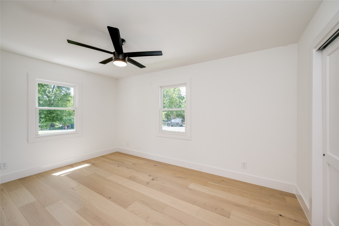 1928 Miles Avenue, Unit 1 Austin, TX 78745 - Photo 20 of 28 an empty room with a window and a ceiling fan