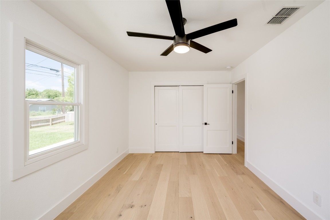 1928 Miles Avenue, Unit 1 Austin, TX 78745 - Photo 22 of 28 a view of a room with a window and a ceiling fan