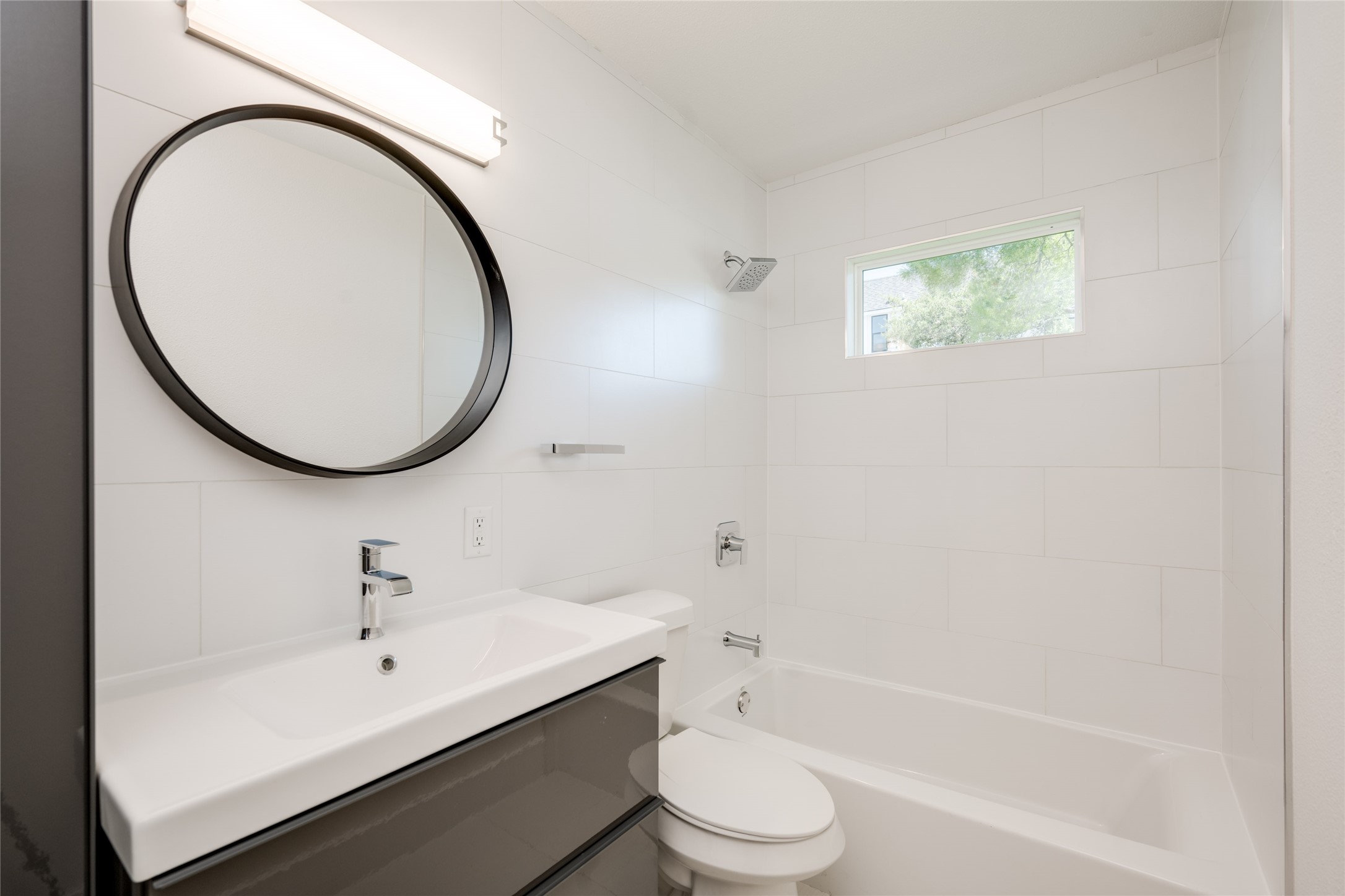 1928 Miles Avenue, Unit 1 Austin, TX 78745 - Photo 23 of 28 a bathroom with a sink a toilet and a mirror