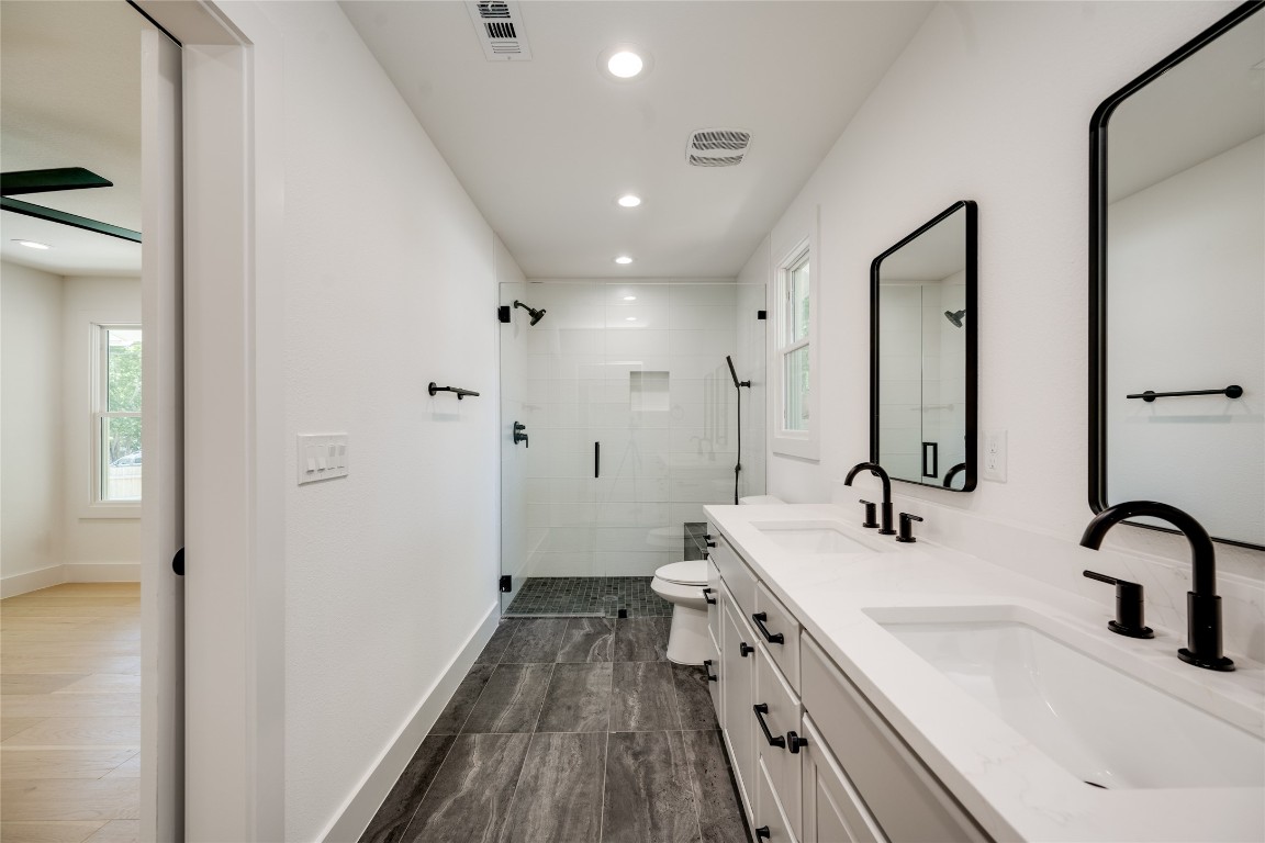 1928 Miles Avenue, Unit 1 Austin, TX 78745 - Photo 25 of 28 a bathroom with a sink and a mirror
