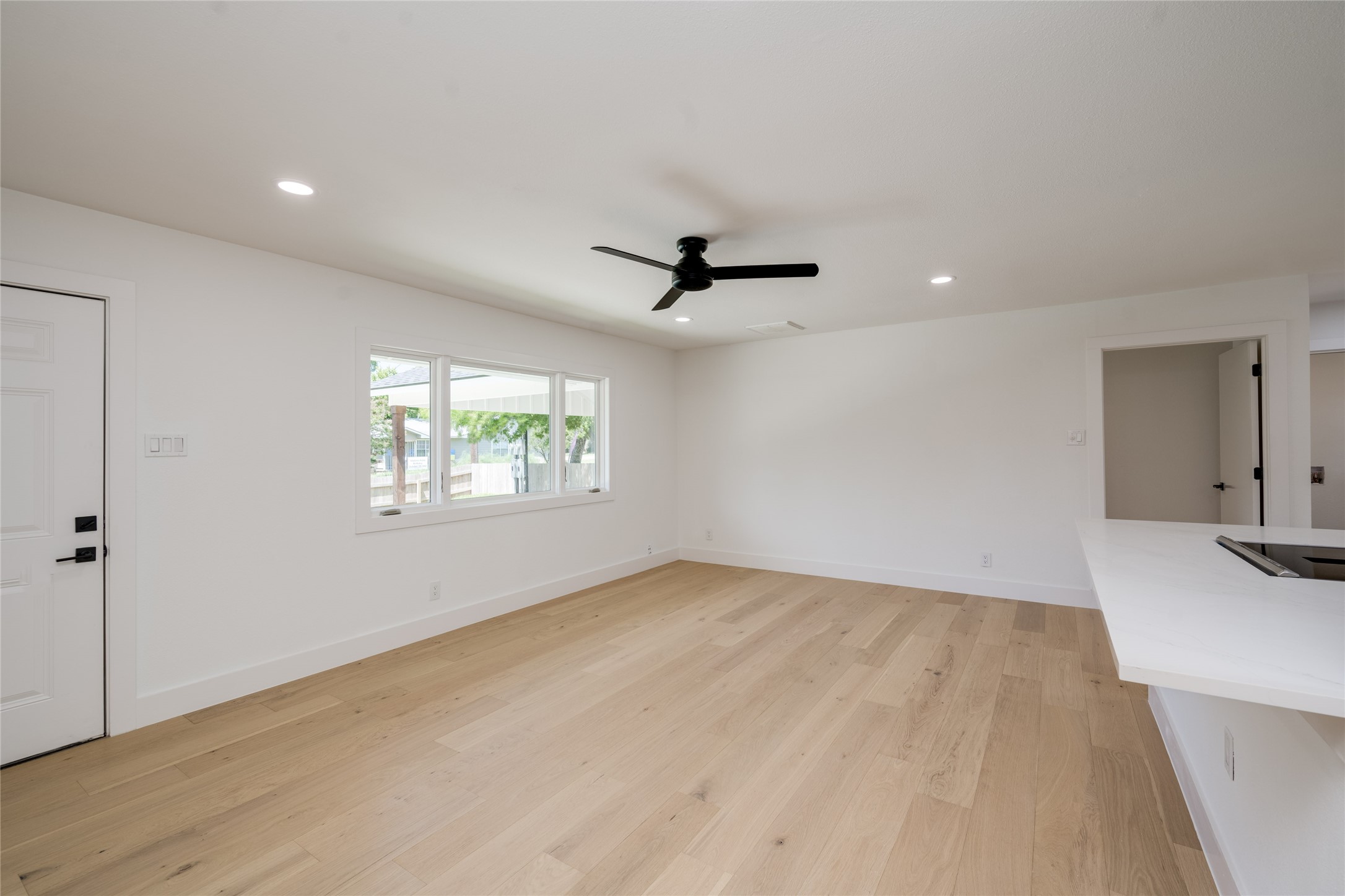 1928 Miles Avenue, Unit 1 Austin, TX 78745 - Photo 5 of 28 wooden floor in an empty room with a window
