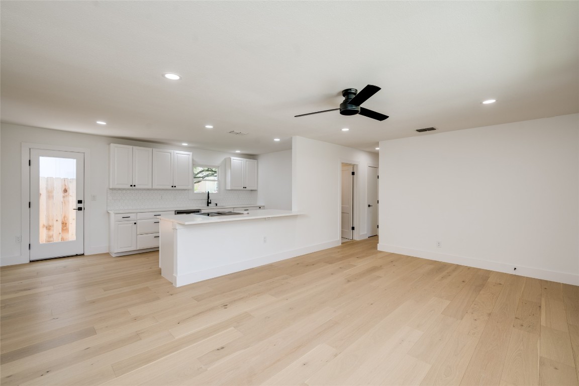1928 Miles Avenue, Unit 1 Austin, TX 78745 - Photo 6 of 28 a view of kitchen with granite countertop cabinets and refrigerator