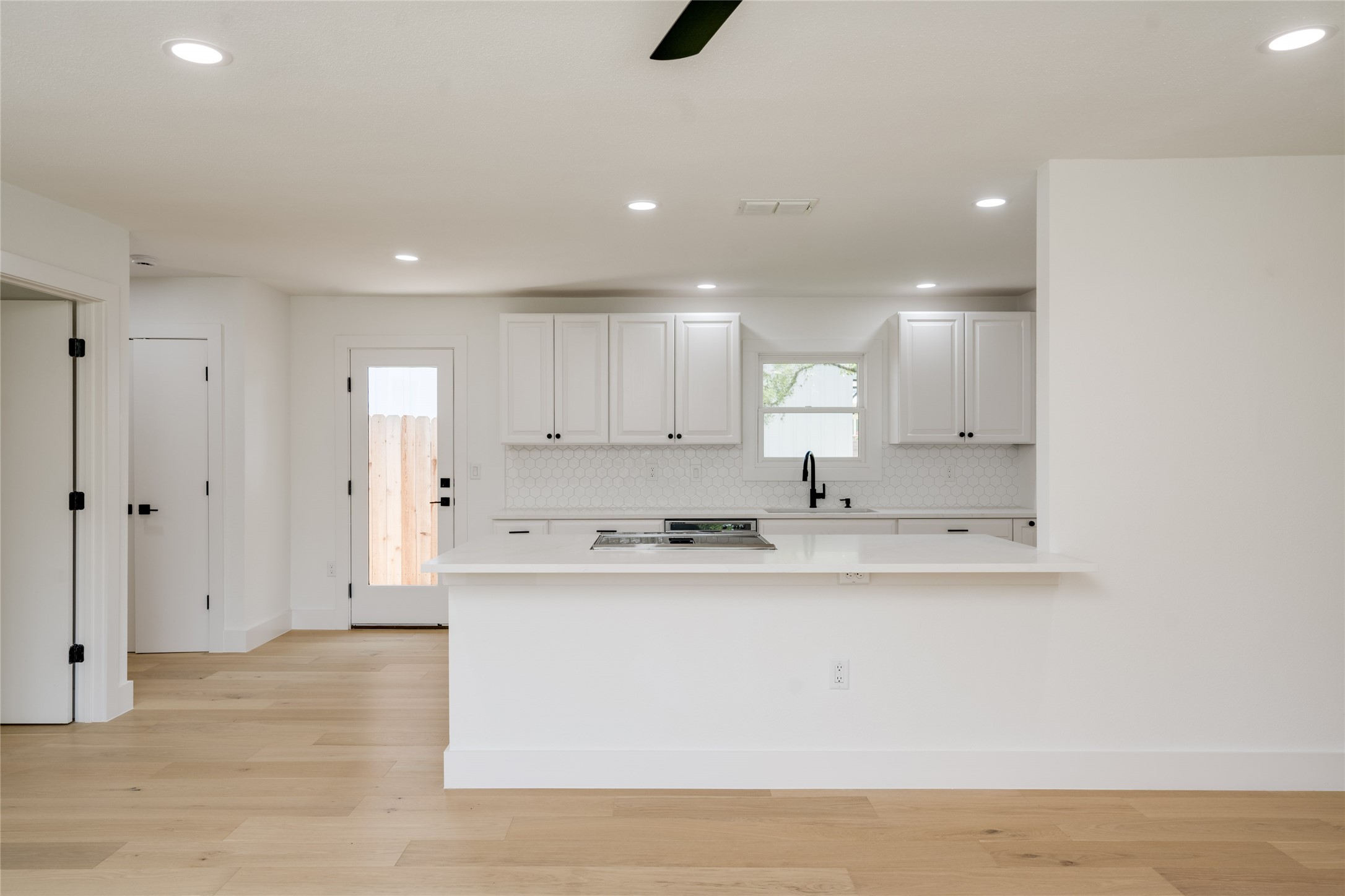 1928 Miles Avenue, Unit 1 Austin, TX 78745 - Photo 7 of 28 a large kitchen with stainless steel appliances granite countertop a sink and cabinets