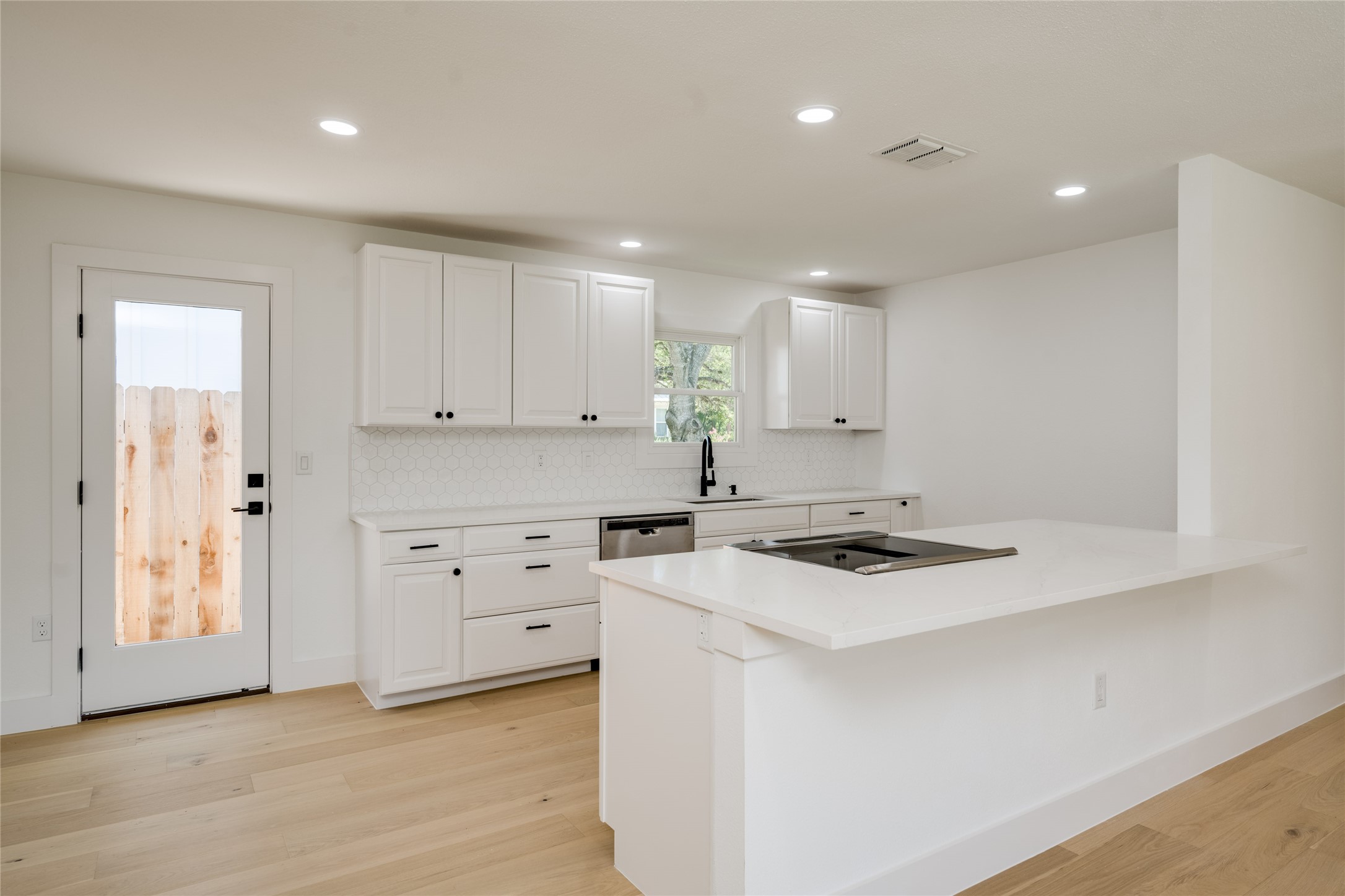 1928 Miles Avenue, Unit 1 Austin, TX 78745 - Photo 8 of 28 a kitchen with cabinets appliances a sink and a window