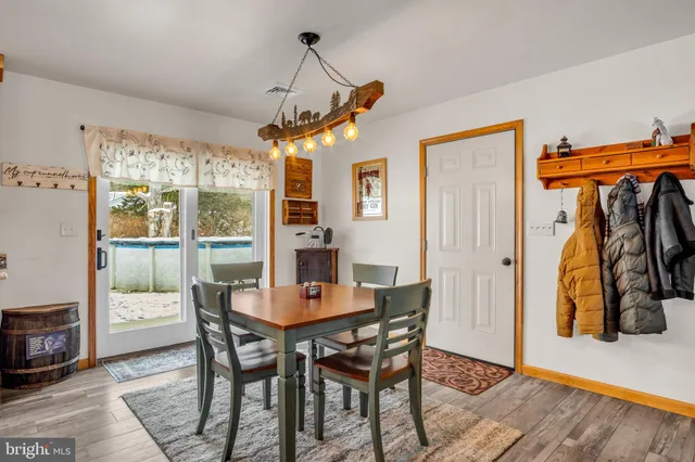 a dining room with furniture and a floor to ceiling window