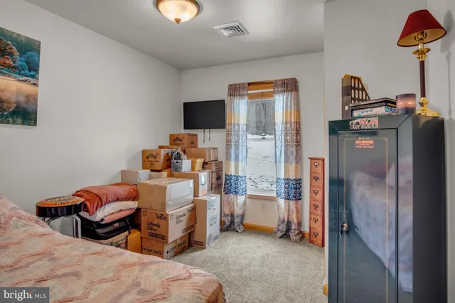 a bedroom with bed and a tv