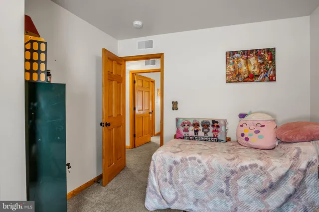 a bedroom with bed and wall painting