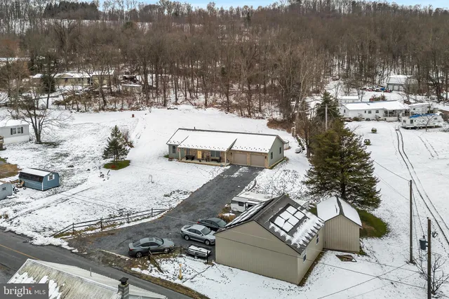 a view of a backyard with snow and trees