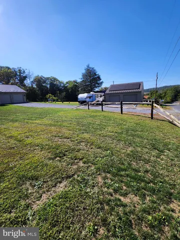 a view of a grassy field with an trees