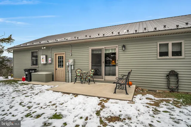 a view of a backyard with a table and chairs