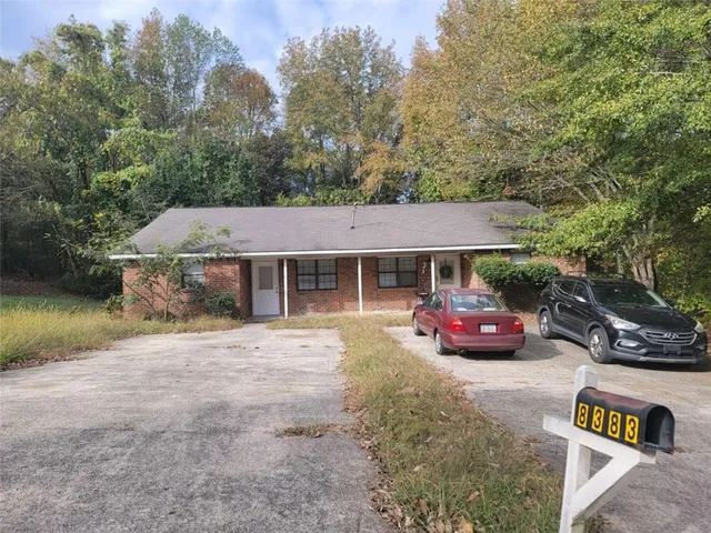 an outdoor view of house with outdoor space and swimming pool