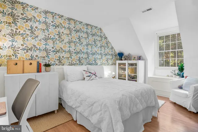 a bedroom with a bed and a couch