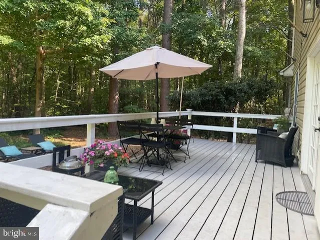 a view of a chairs and table on the wooden deck