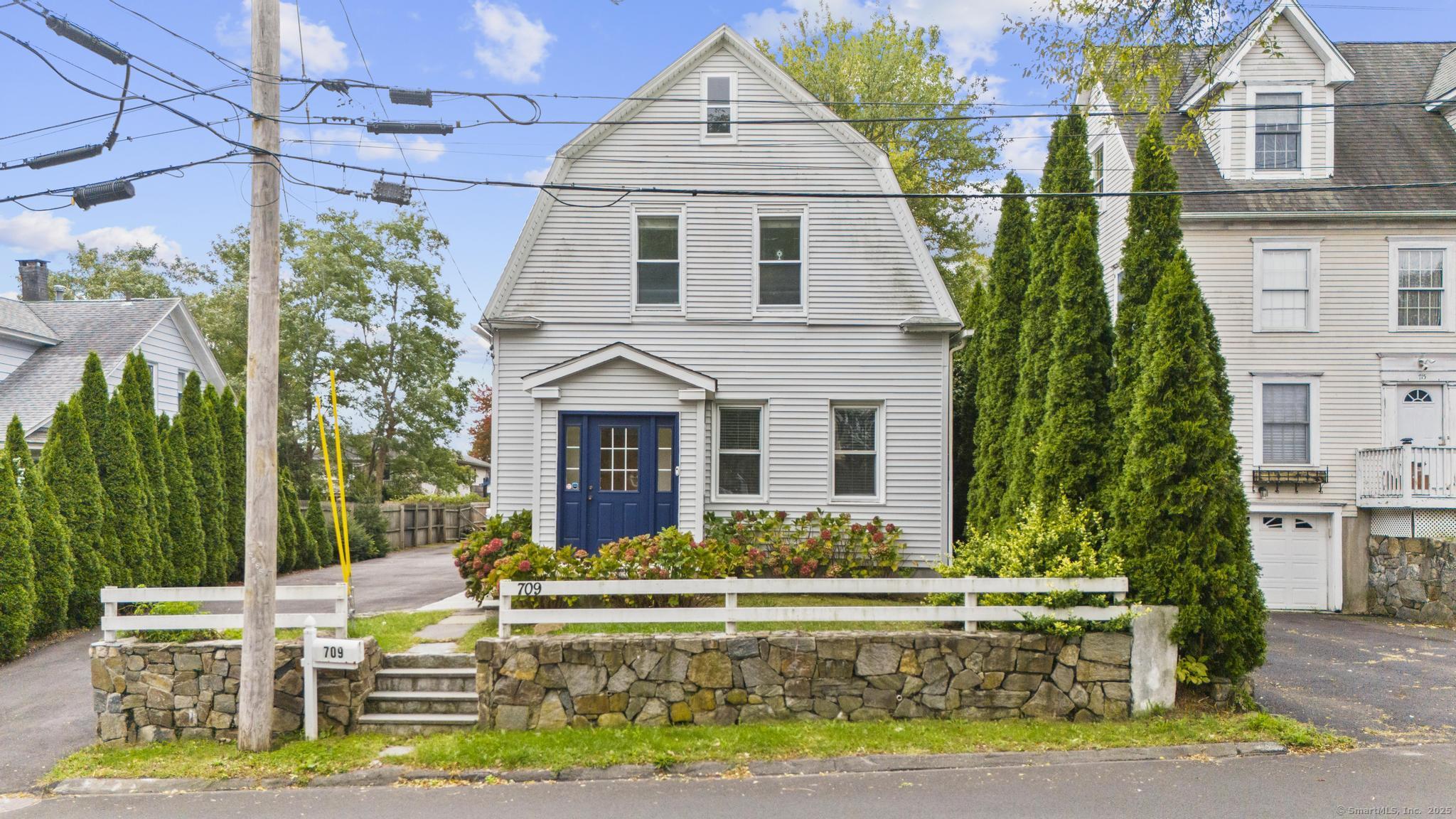 a front view of a house with a yard table and chairs