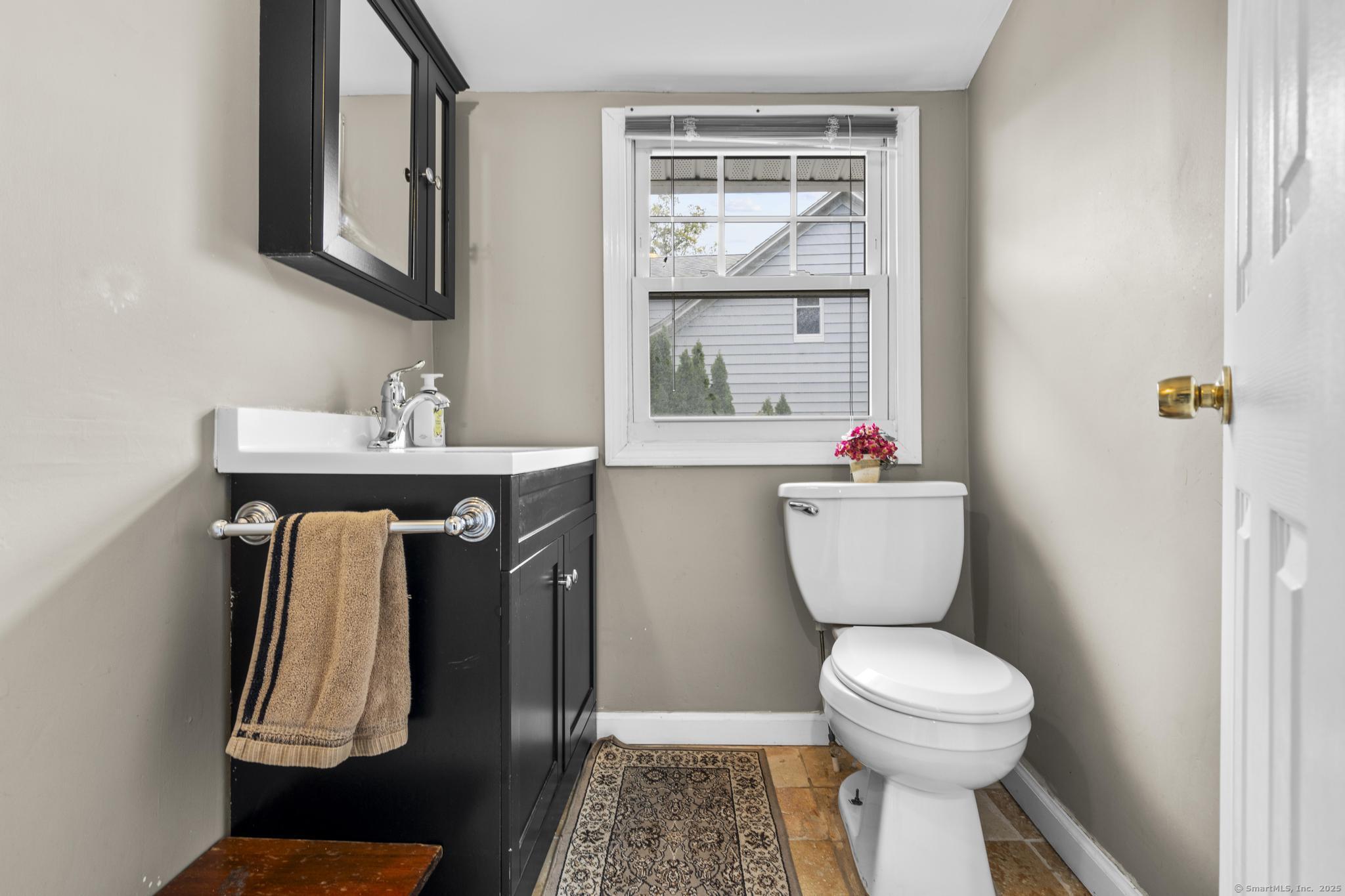709 Tunxis Hill Road Fairfield, CT 06825 - Photo 12 of 30 a bathroom with a toilet sink and mirror