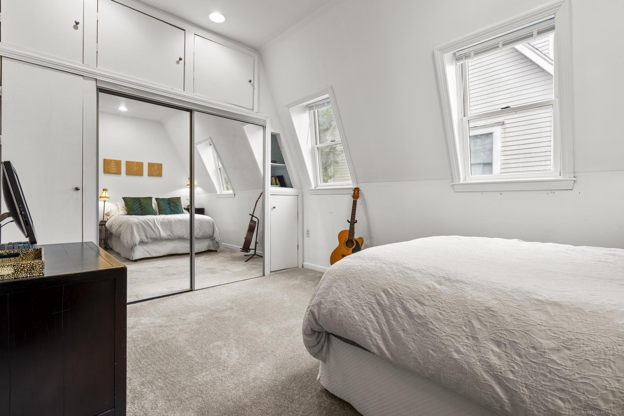 709 Tunxis Hill Road Fairfield, CT 06825 - Photo 17 of 30 a bedroom with a bed and a window