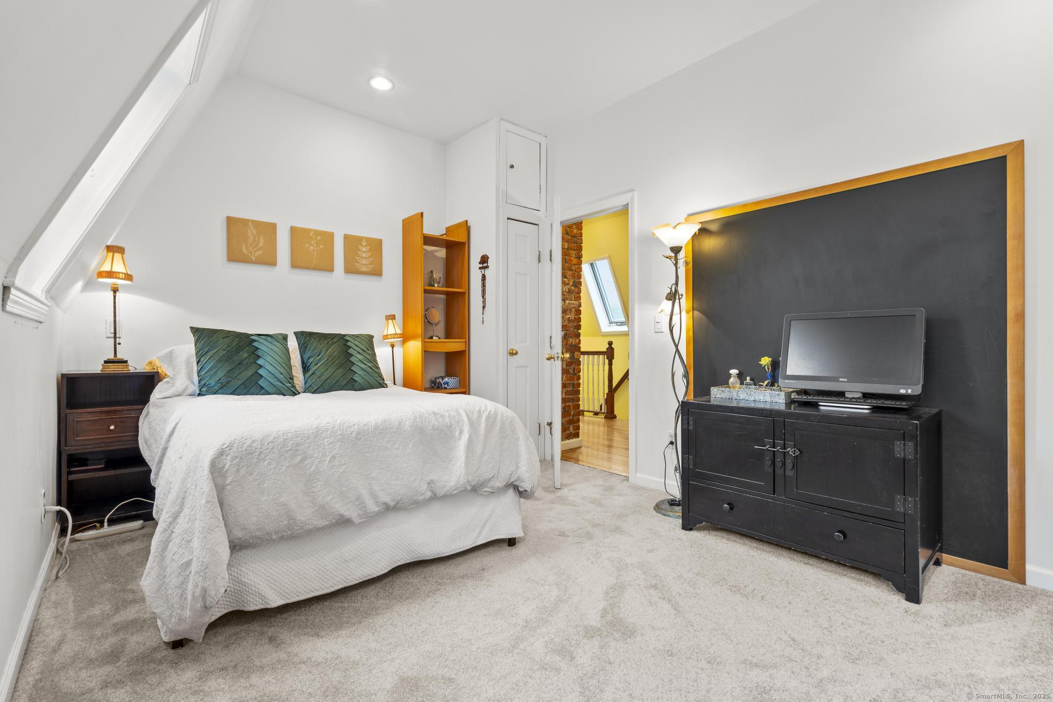 709 Tunxis Hill Road Fairfield, CT 06825 - Photo 18 of 30 a bedroom with a bed and dresser