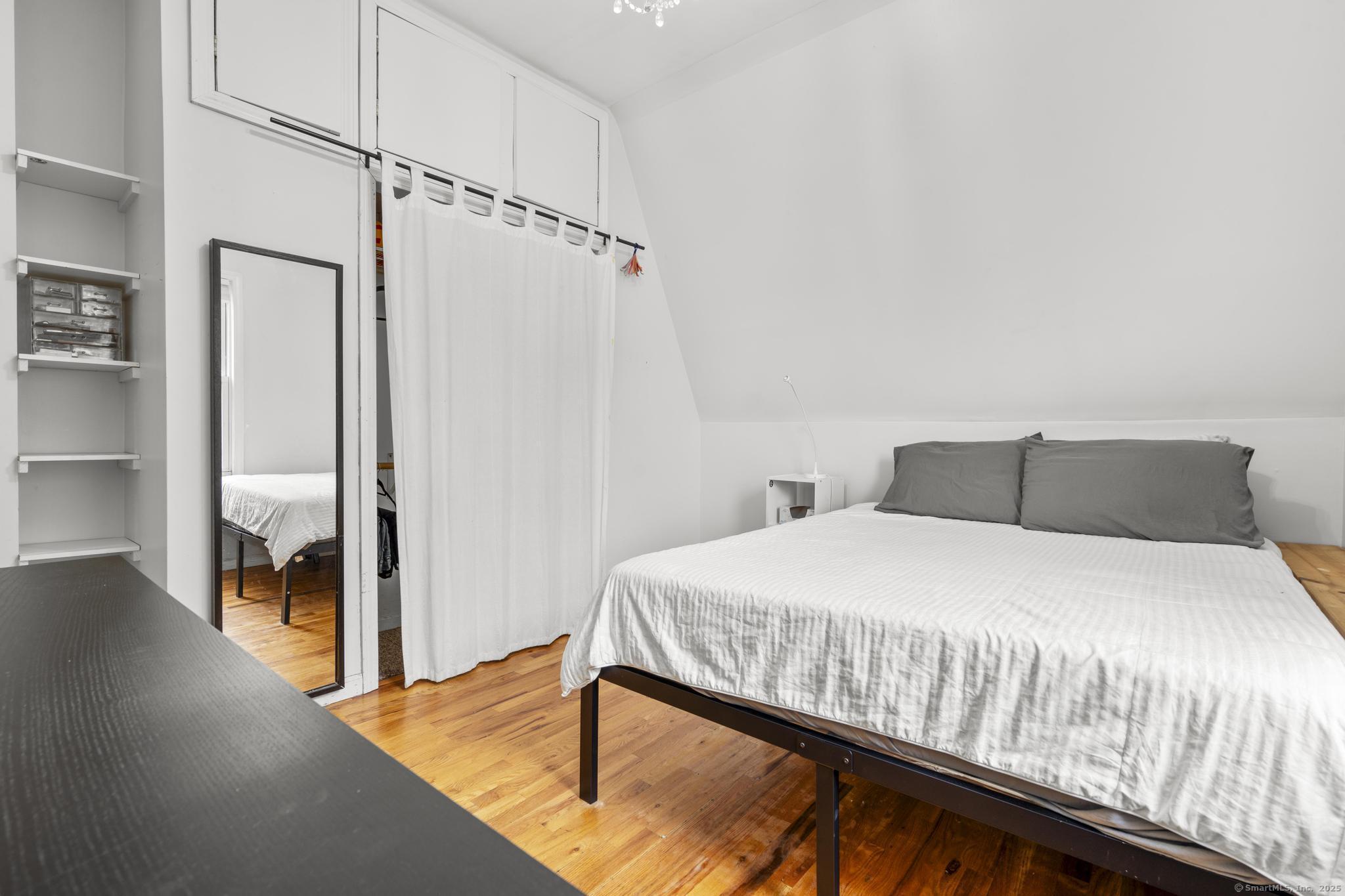 709 Tunxis Hill Road Fairfield, CT 06825 - Photo 19 of 30 a bedroom with a bed and a walk in closet