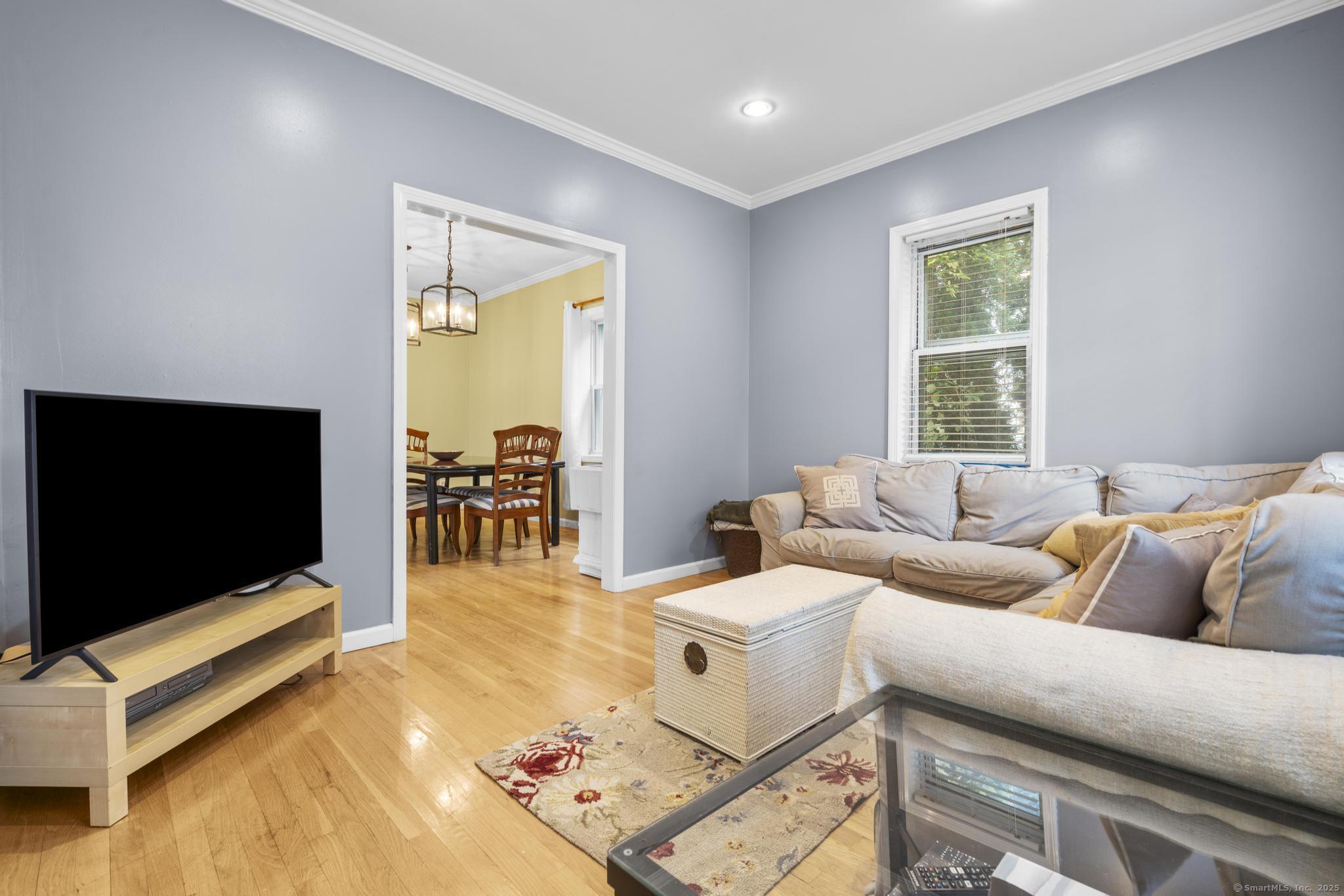 709 Tunxis Hill Road Fairfield, CT 06825 - Photo 4 of 30 a living room with furniture and a flat screen tv