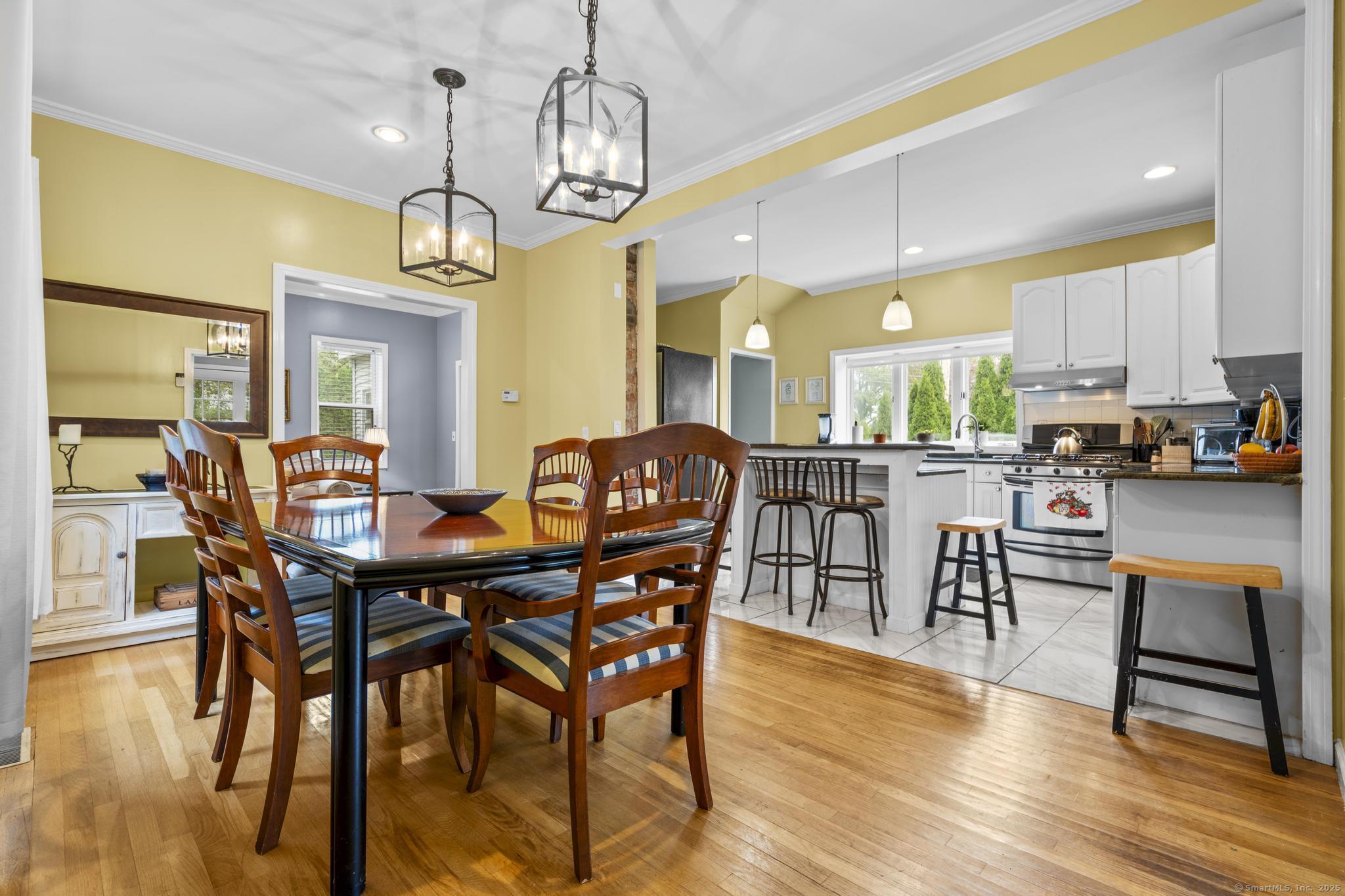 709 Tunxis Hill Road Fairfield, CT 06825 - Photo 7 of 30 a view of a dining room with furniture and wooden floor