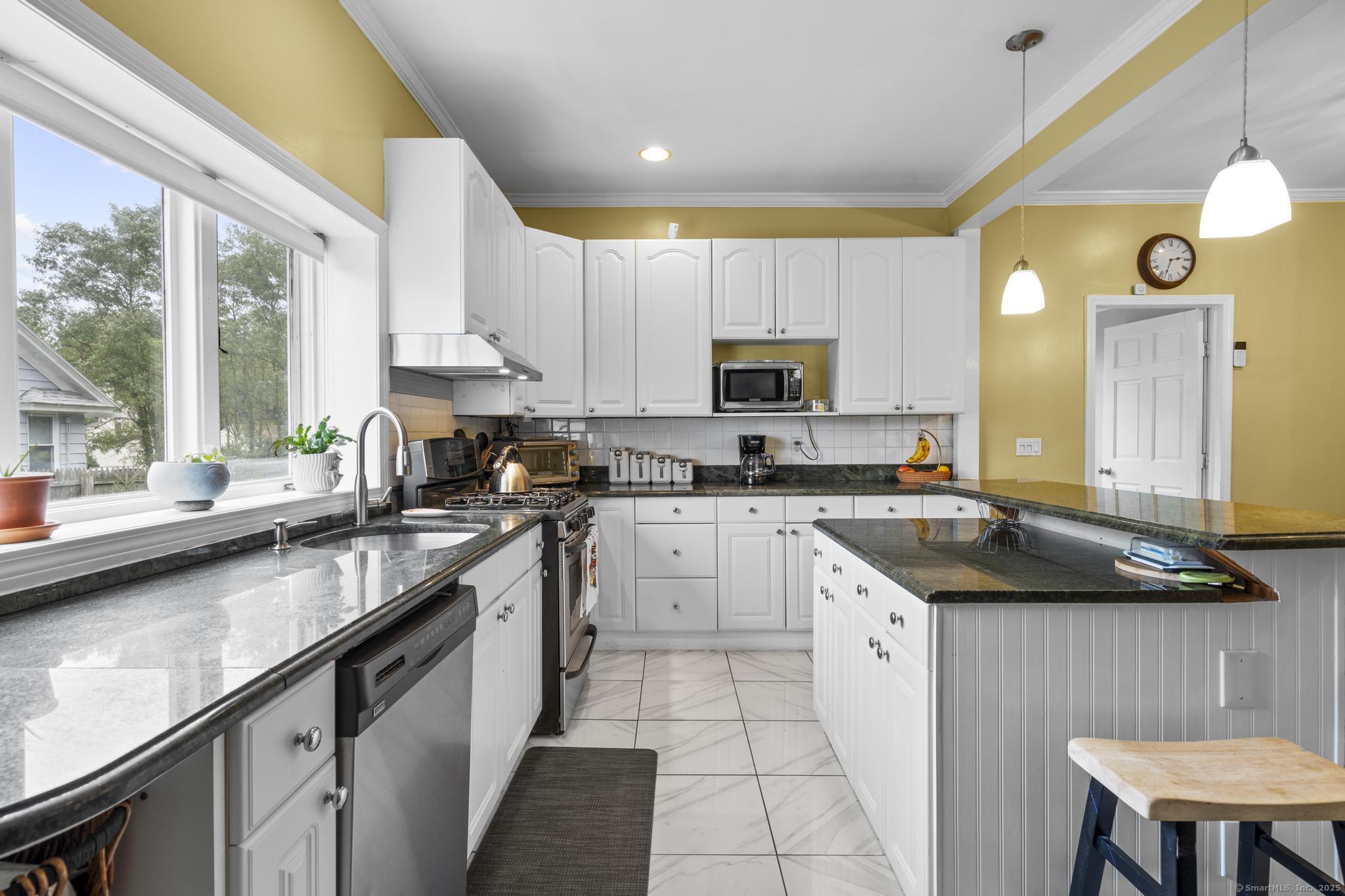 709 Tunxis Hill Road Fairfield, CT 06825 - Photo 10 of 30 a kitchen with a sink cabinets and window