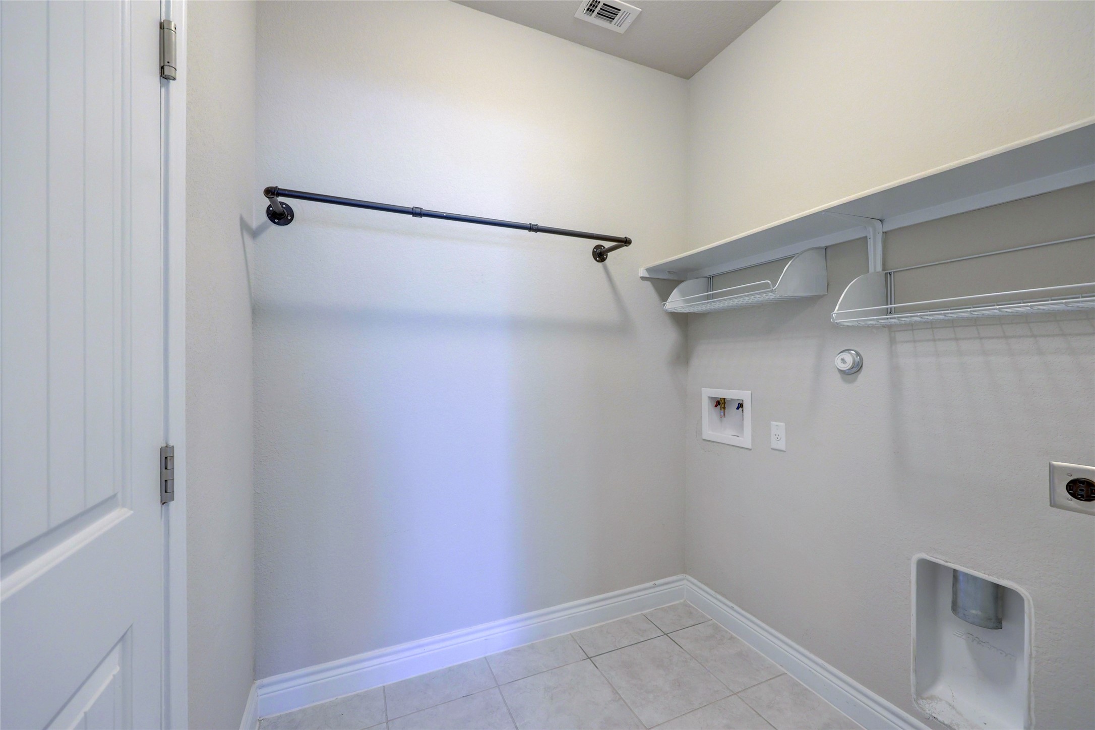 431 Millard Street Georgetown, TX 78628 - Photo 13 of 36 Laundry room featuring hookup for a washing machine, light tile patterned flooring, electric dryer hookup, and gas dryer hookup