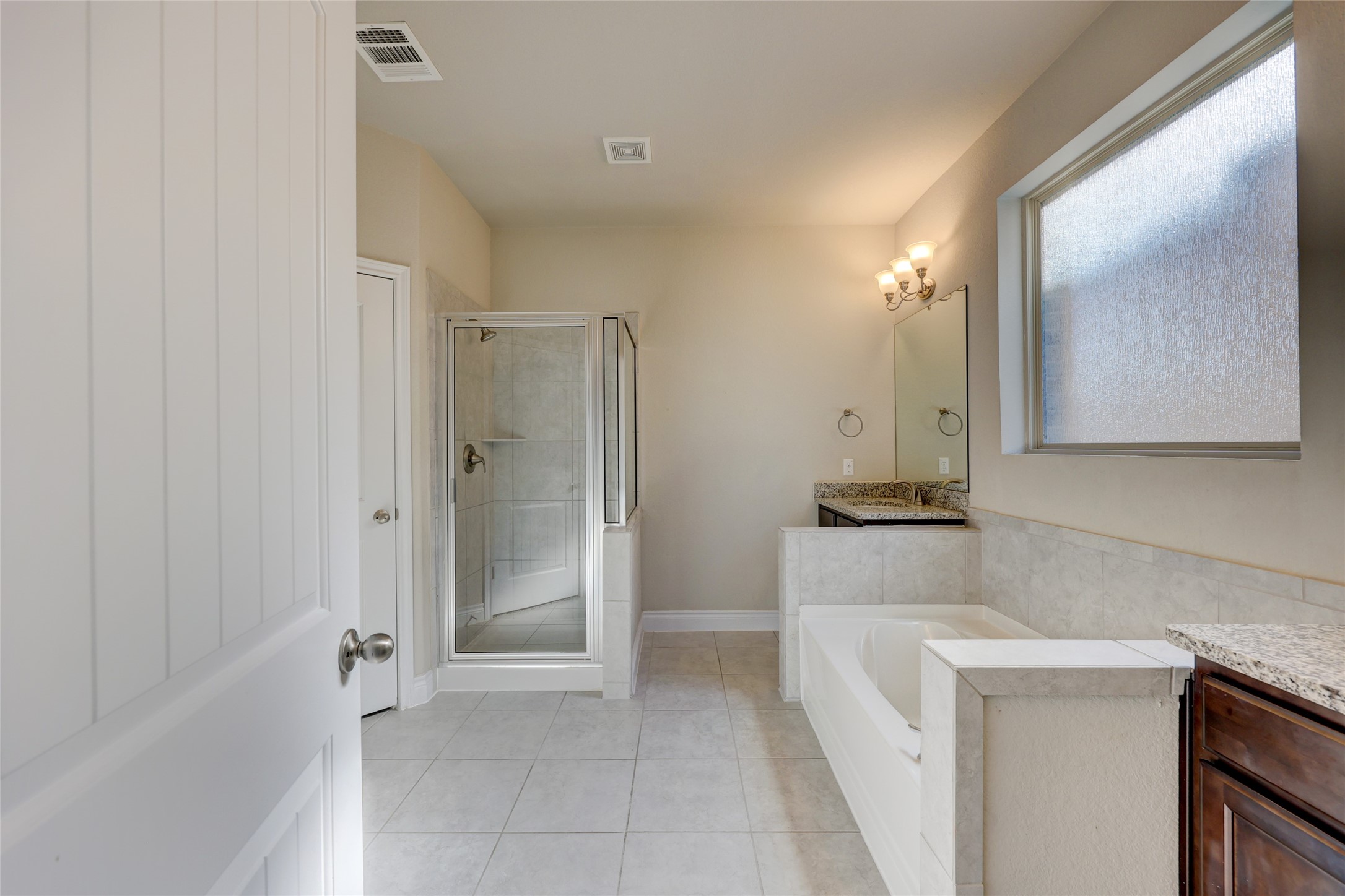 431 Millard Street Georgetown, TX 78628 - Photo 19 of 36 Full bathroom featuring vanity, a garden tub, a shower stall, and light tile patterned flooring