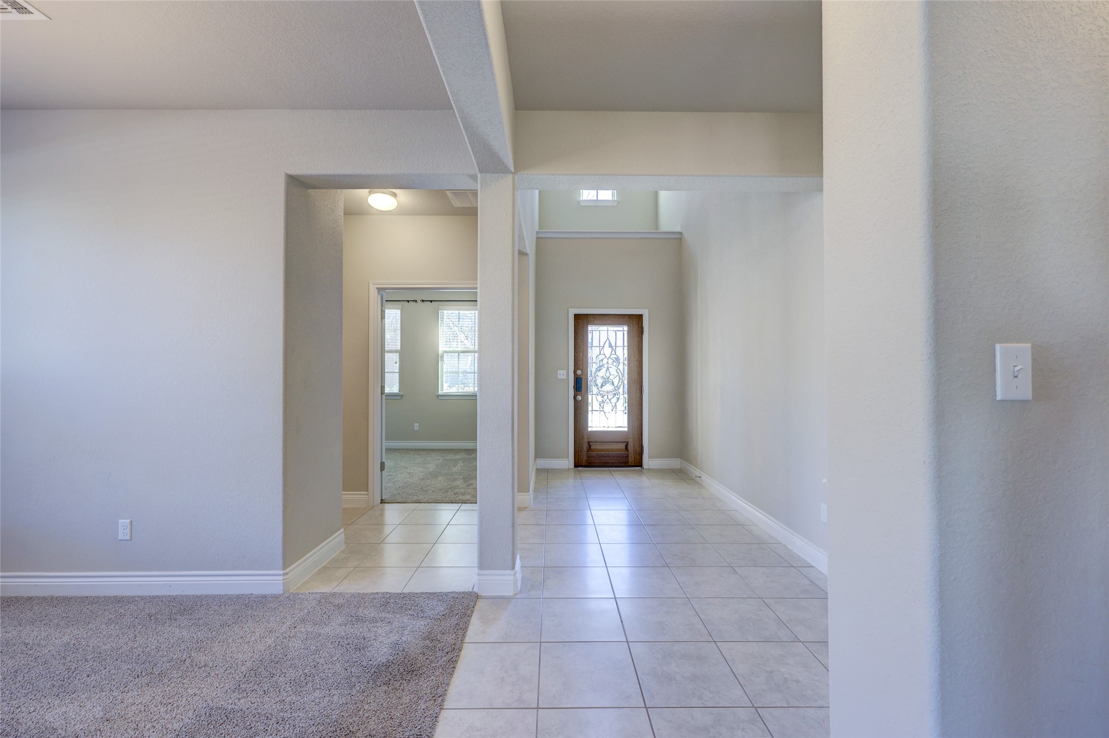431 Millard Street Georgetown, TX 78628 - Photo 5 of 36 Foyer entrance featuring light tile patterned flooring and light colored carpet