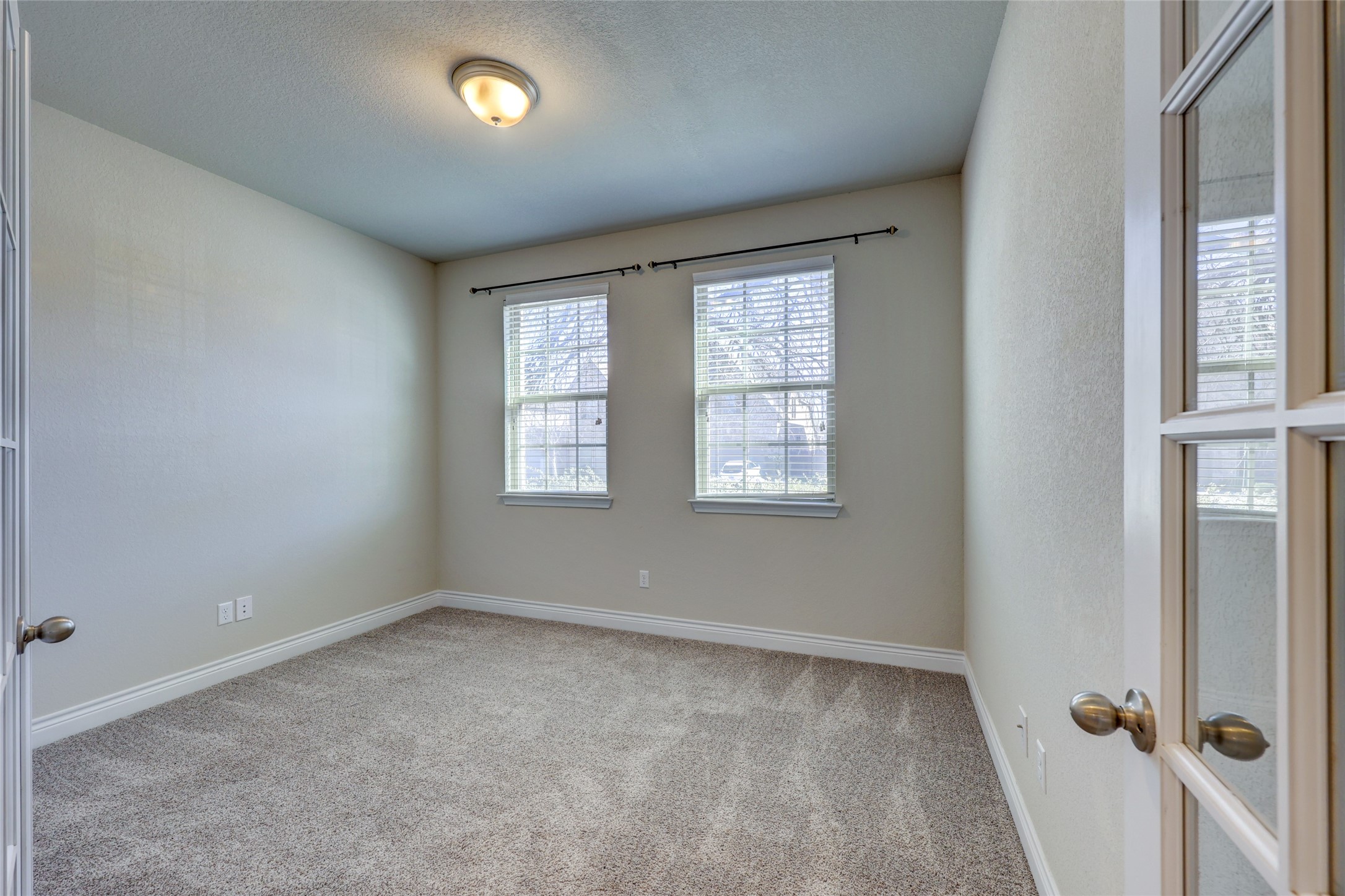 431 Millard Street Georgetown, TX 78628 - Photo 8 of 36 Unfurnished Office room featuring light carpet and a textured ceiling