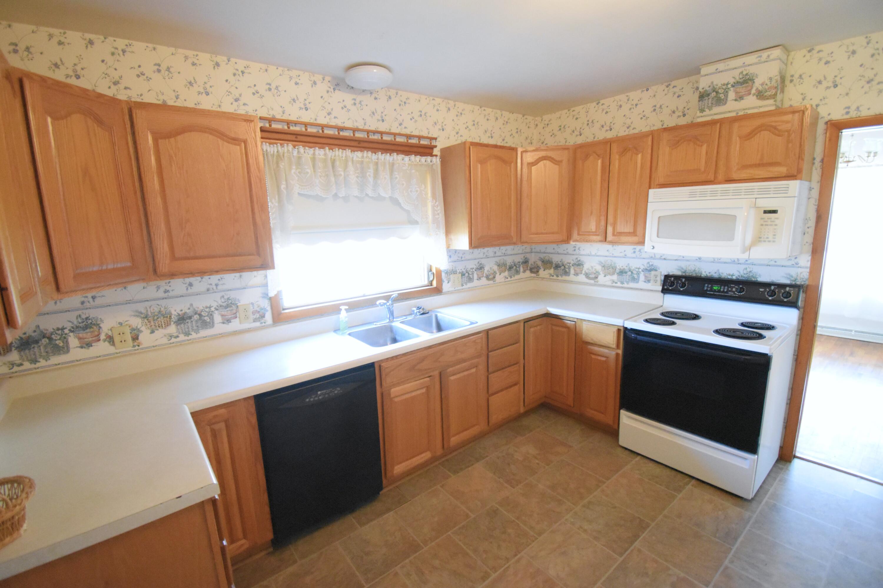 328 South Weston Street Rensselaer, IN 47978 - Photo 13 of 39 a kitchen with stainless steel appliances granite countertop a sink stove and refrigerator