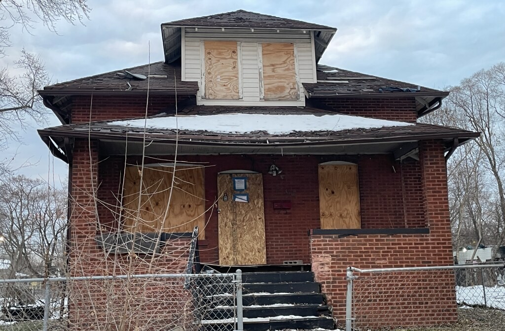 a front view of a house with barbeque grill