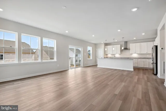 a view of kitchen with wooden floor and windows