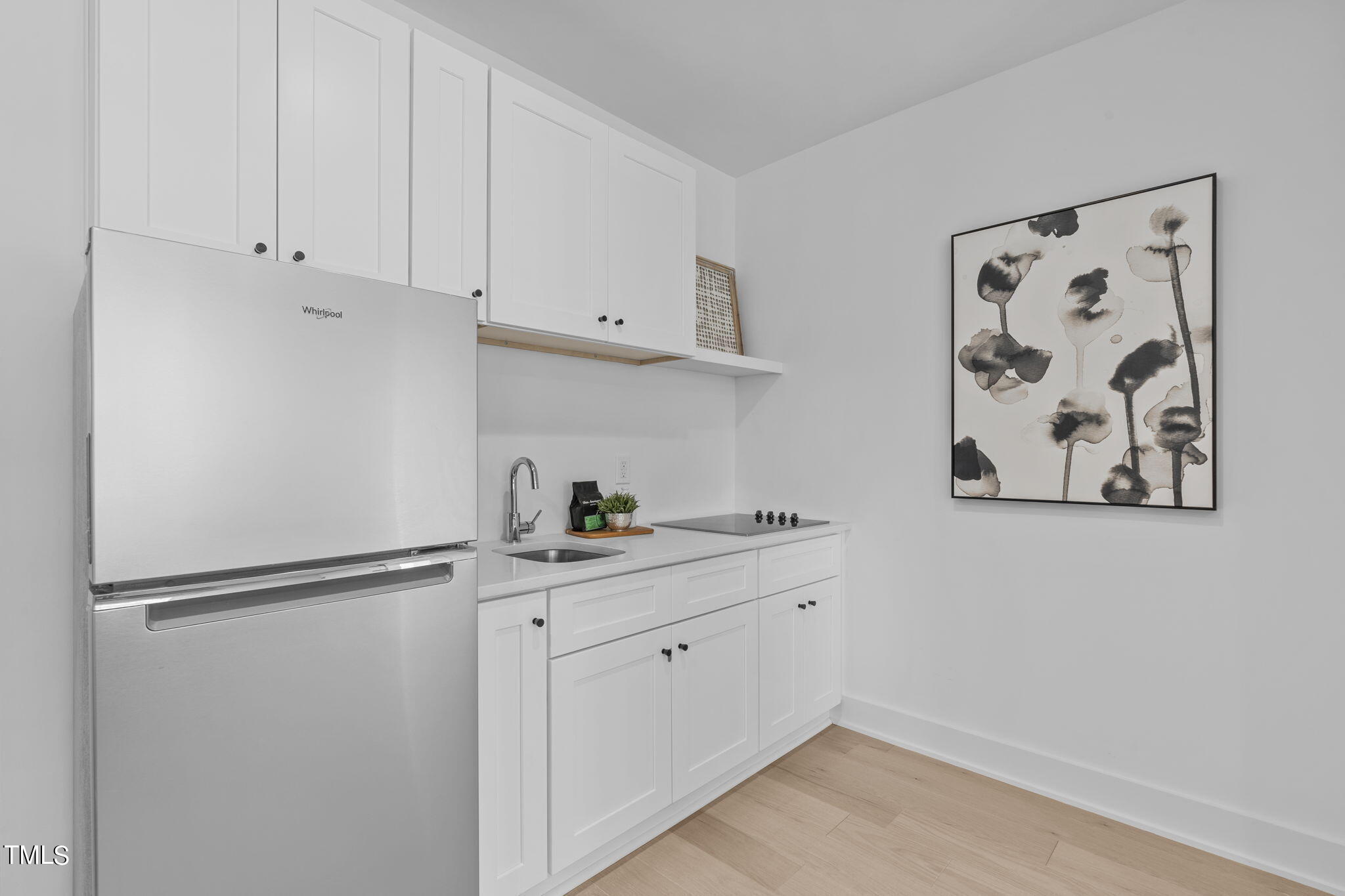 861 Athens Drive, Unit 101 Raleigh, NC 27606 - Photo 26 of 52 a kitchen with white cabinets and white appliances