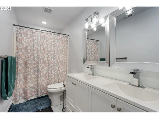 a bathroom with a sink a toilet and a mirror