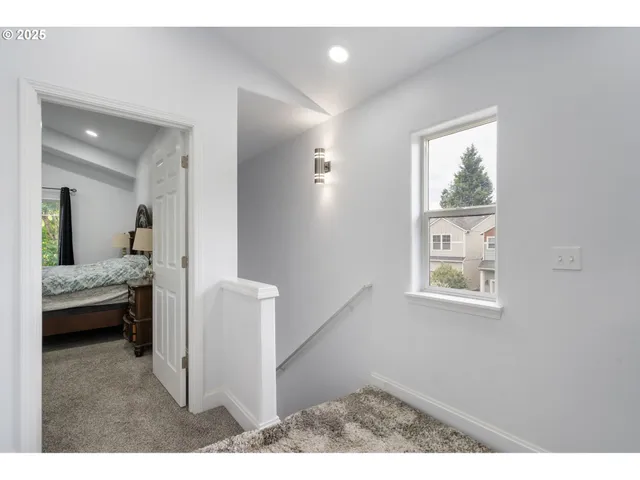 a view of a bedroom with wooden floor and cabinet