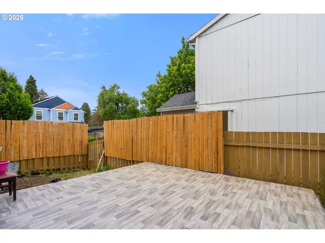 a backyard of a house with table and chairs