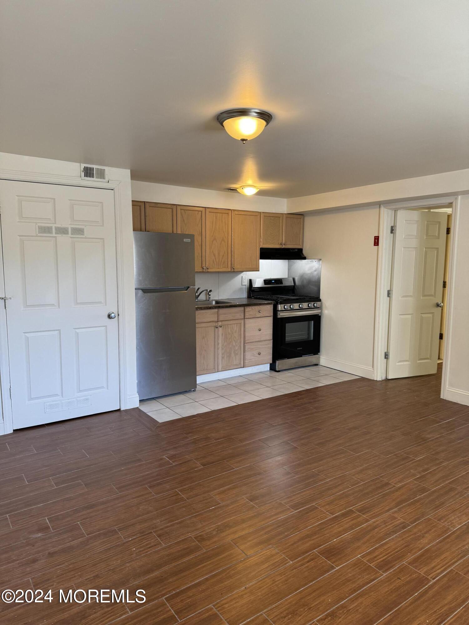 109 2nd Avenue, Unit I Bradley Beach, NJ 07720 - Photo 2 of 8 a view of a kitchen with a dishwasher and a refrigerator