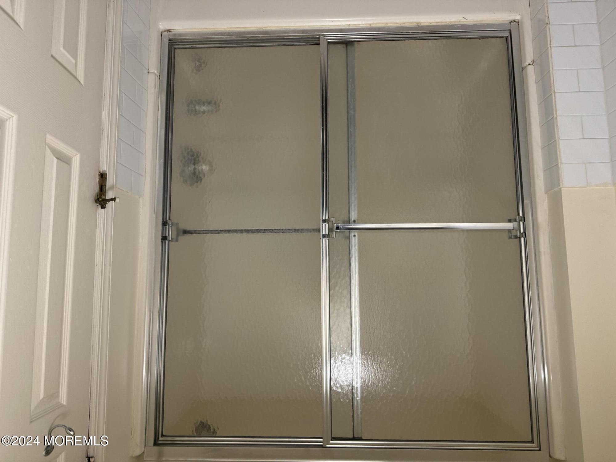 109 2nd Avenue, Unit I Bradley Beach, NJ 07720 - Photo 8 of 8 a bathroom with a glass shower door