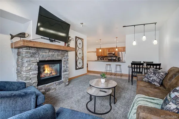 a living room with furniture a flat screen tv and a fireplace