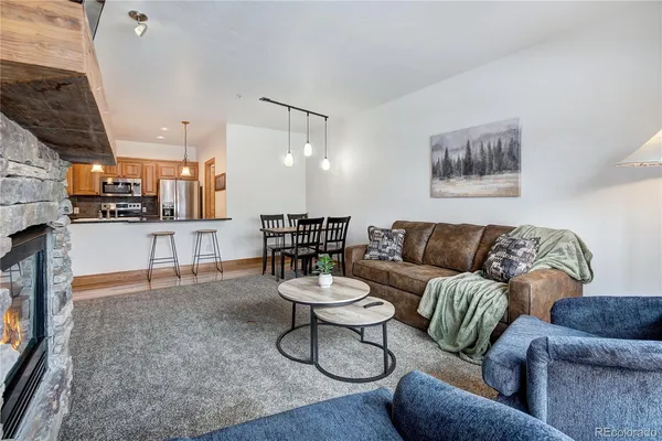 a living room with furniture and kitchen view