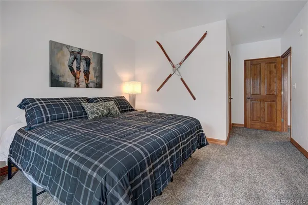 a spacious bathroom with a granite countertop sink toilet a mirror and shower