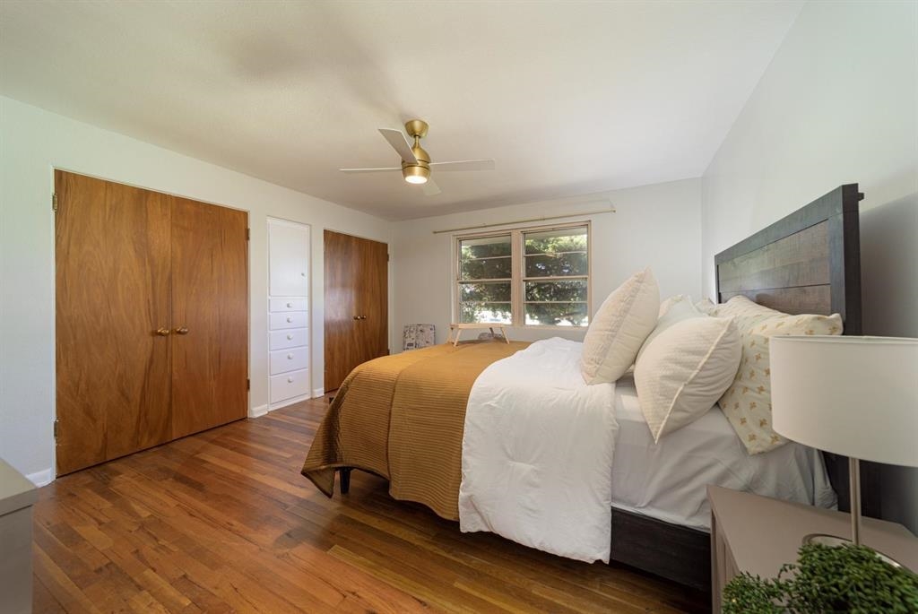604-26 26 1/2 Road Grand Junction, CO 81506 - Photo 12 of 21 a bedroom with a bed and wooden floor