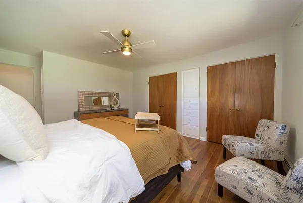 a bedroom with a bed and wooden floor