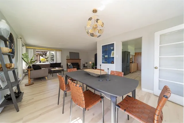 a view of a dining room with furniture and a window