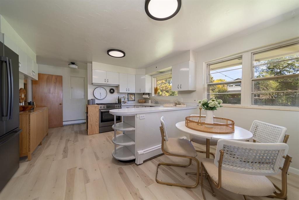 604-26 26 1/2 Road Grand Junction, CO 81506 - Photo 9 of 21 a kitchen with a table chairs a sink dishwasher and cabinets