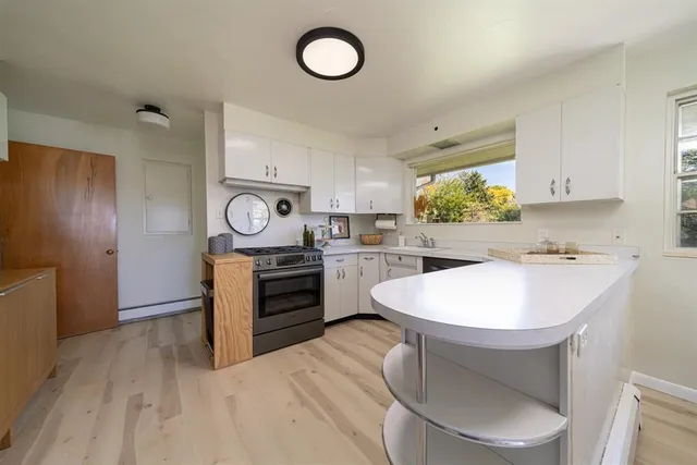 a kitchen with stainless steel appliances a stove a sink and a refrigerator