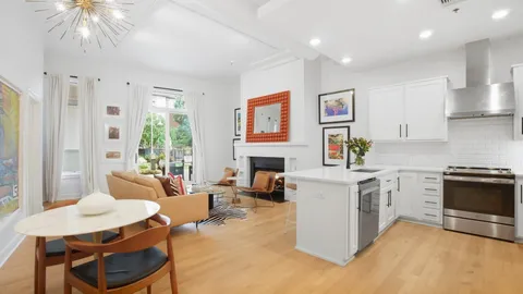 a living room with furniture a fireplace and a table